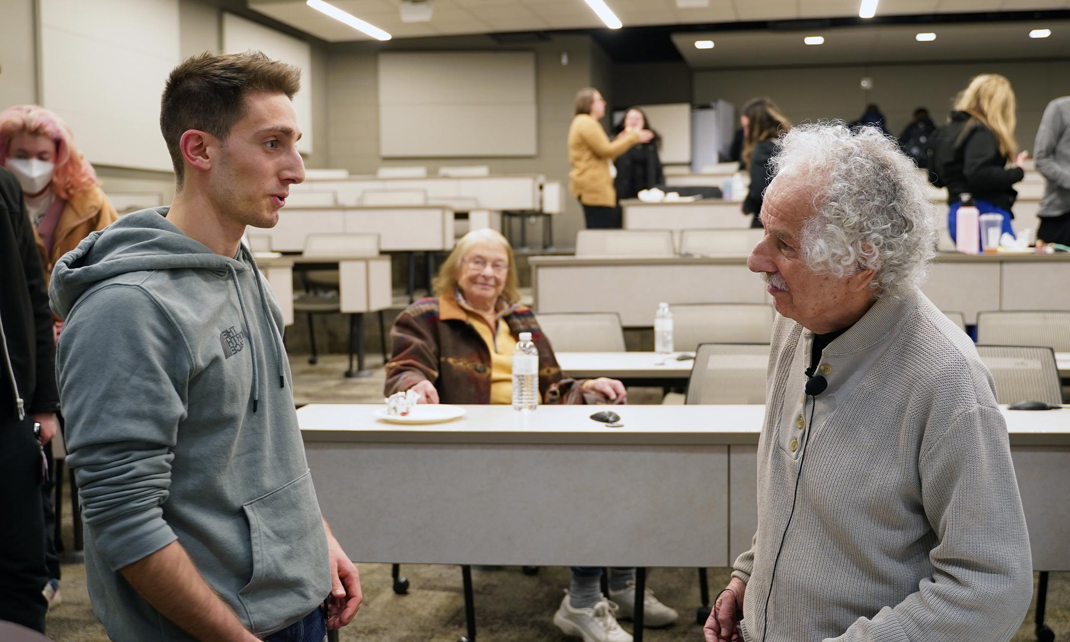 An image of a Holocaust survivor talking to a med student