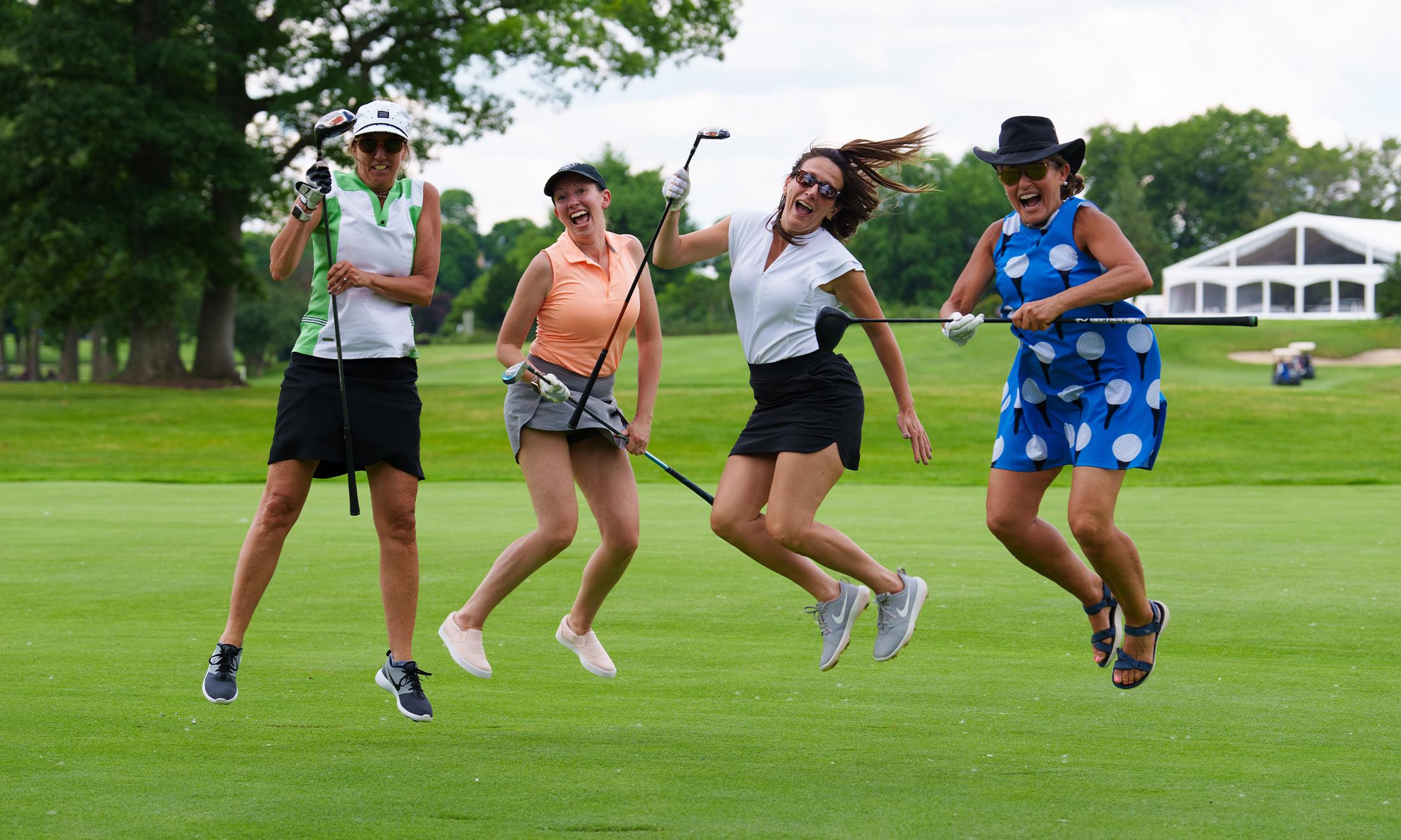 An image of a group of golfers jumping